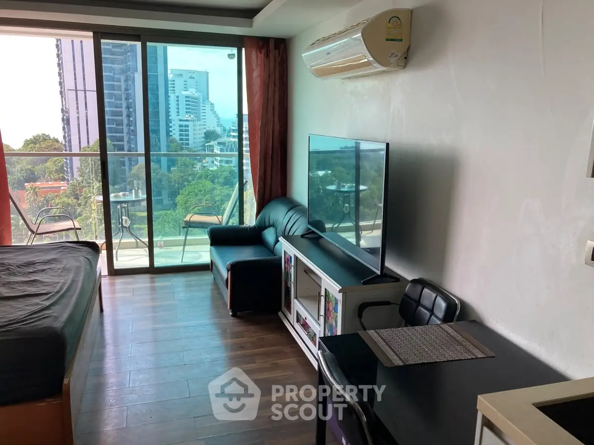 Modern studio apartment with balcony and city view, featuring sleek furniture and air conditioning.