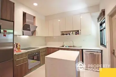 Modern kitchen with sleek cabinetry and central island in stylish apartment