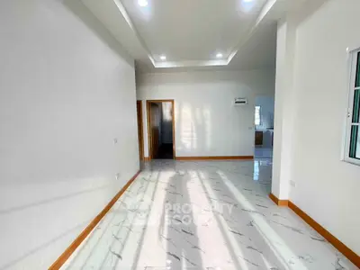 Spacious modern living room with elegant marble flooring and recessed lighting.