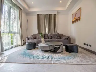Spacious living room with modern decor and large windows for natural light.