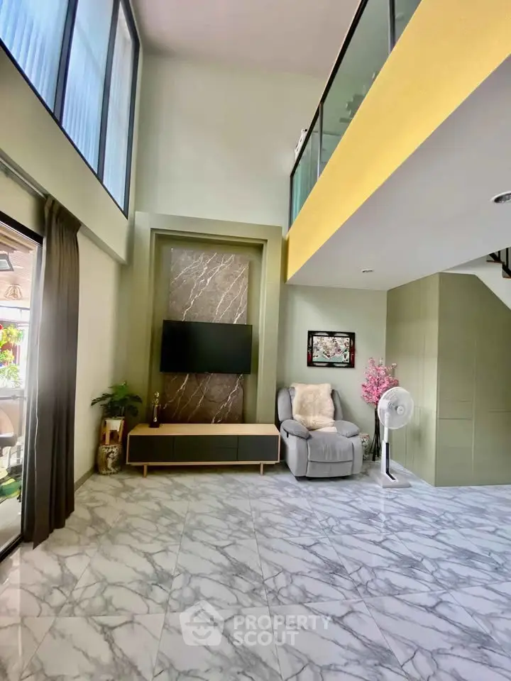 Spacious modern living room with high ceilings and elegant marble flooring