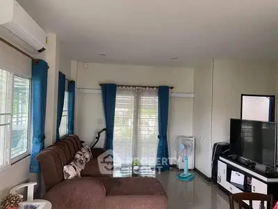 Spacious living room with modern decor and large windows for natural light.