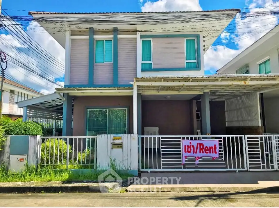 Charming two-story house for rent with modern facade and gated entrance.