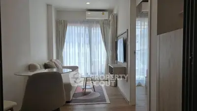 Modern living room with stylish furniture and large windows in a cozy apartment.