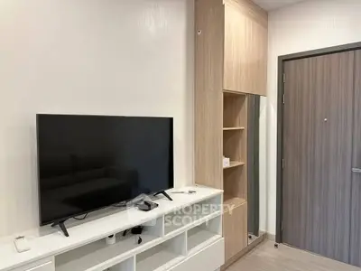 Modern living room with sleek TV setup and stylish wooden cabinetry