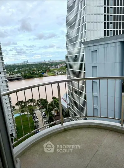 Stunning high-rise balcony view overlooking river and cityscape, perfect for urban living enthusiasts.