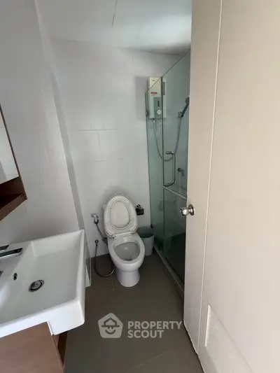 Compact bathroom with modern fixtures and glass shower enclosure