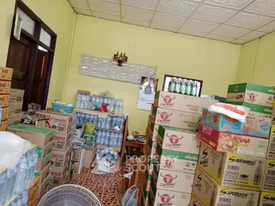 Storage room filled with boxes and bottled water, ideal for inventory management.