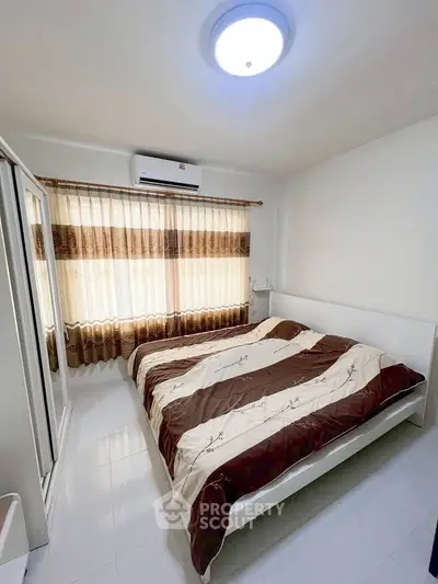 Cozy bedroom with modern decor and ample natural light