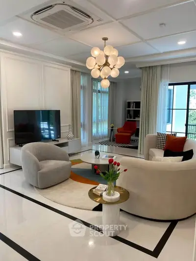 Luxurious modern living room with elegant furniture and stylish decor, featuring a cozy seating area and large windows.