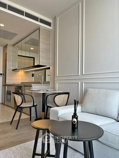 Modern open-plan living room with stylish kitchen and elegant furniture in a contemporary apartment.