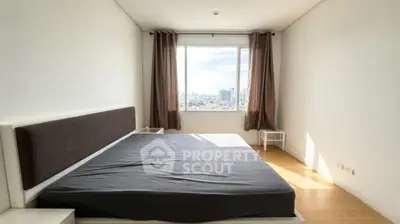 Spacious bedroom with city view and natural light