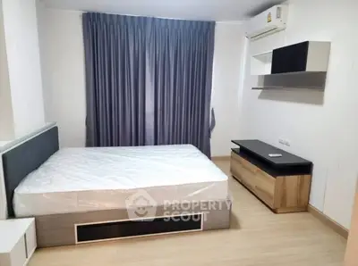 Modern bedroom with sleek furniture and stylish curtains in a cozy apartment.