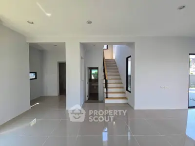 Modern minimalist interior with sleek staircase and glossy tiled flooring