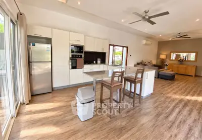 Spacious open-plan kitchen and living room with modern appliances and stylish decor.