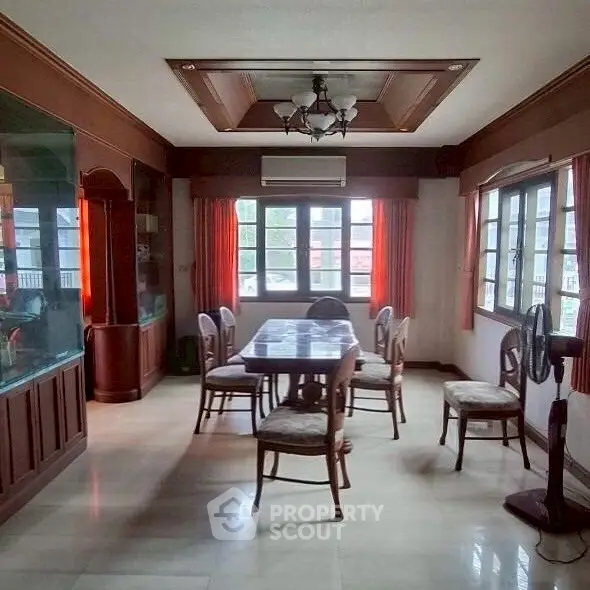 Spacious dining room with elegant wooden accents and large windows for natural light.