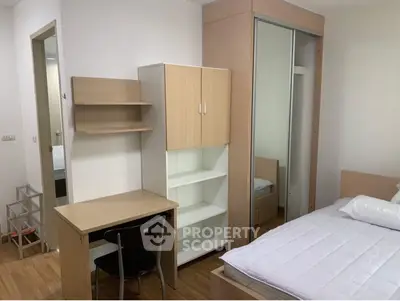 Modern bedroom with sleek furniture and ample storage space, perfect for urban living.