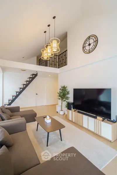 Spacious modern living room with high ceiling and stylish decor