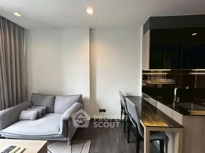 Modern living room with cozy sofa and sleek dining area in open layout.