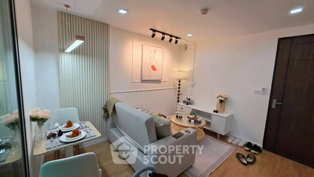 Cozy modern living room with stylish decor and dining area, perfect for urban living.
