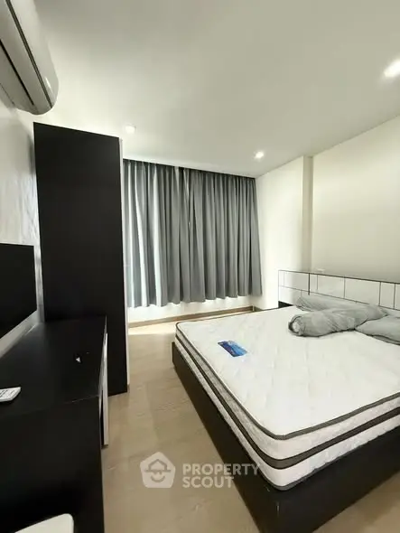 Modern bedroom with sleek furniture and natural light