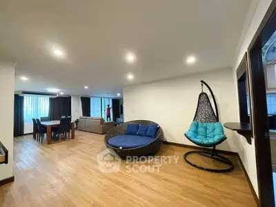 Spacious modern living room with unique round seating and dining area, perfect for entertaining.