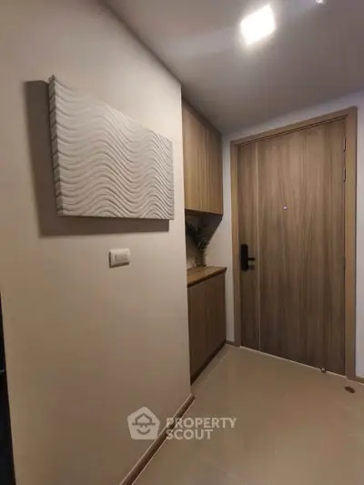 Modern apartment entrance with stylish wooden door and sleek decor