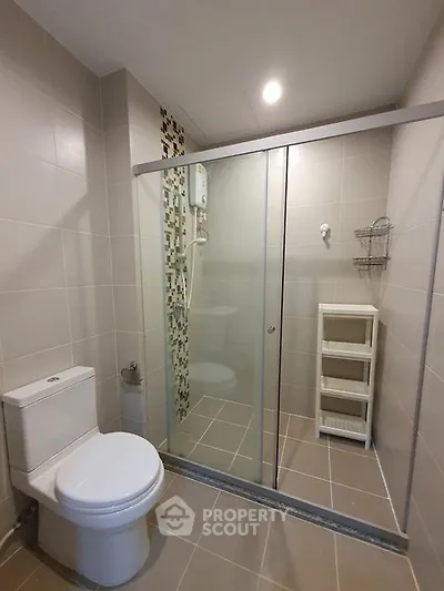 Modern bathroom with glass shower and sleek tile design