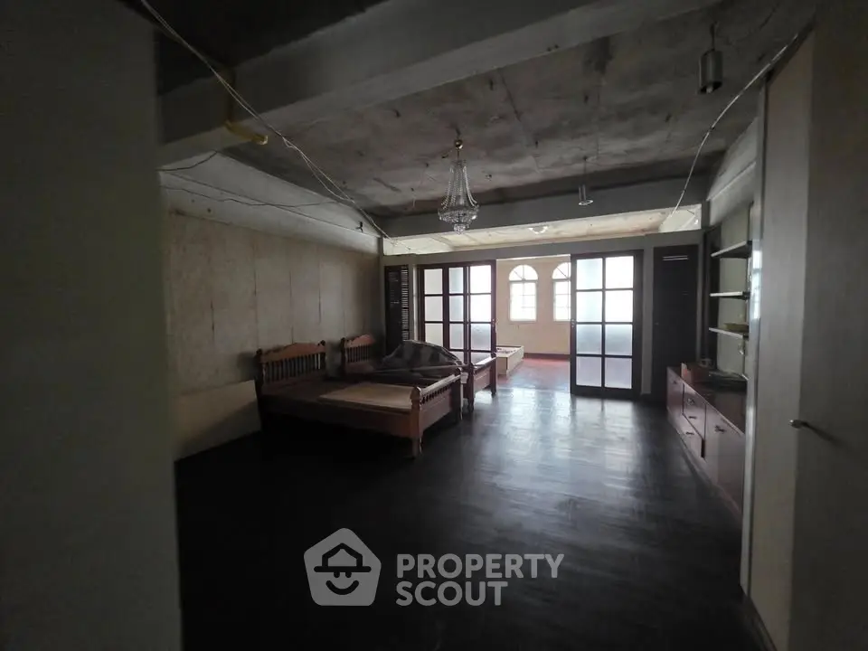 Spacious bedroom with rustic charm and large windows for natural light.