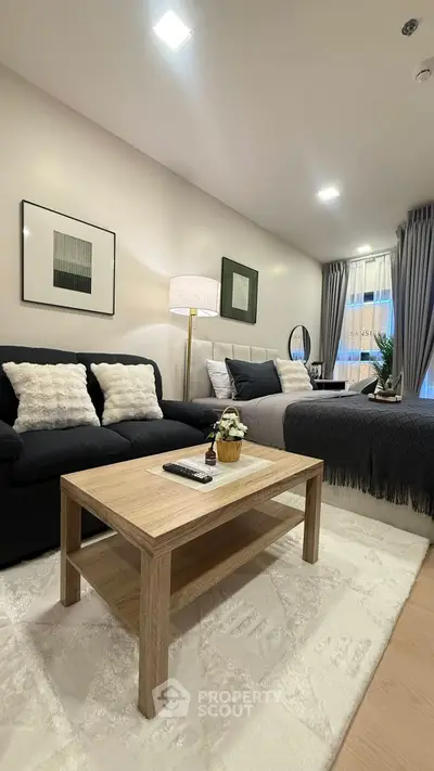 Modern living room with cozy sofa, stylish decor, and natural light, perfect for relaxation and entertaining.