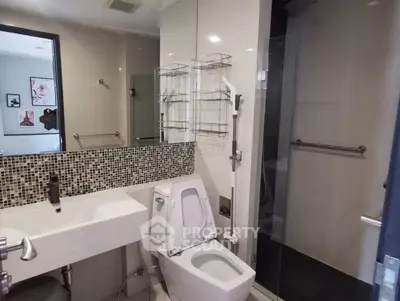 Modern bathroom with sleek fixtures and mosaic tile backsplash