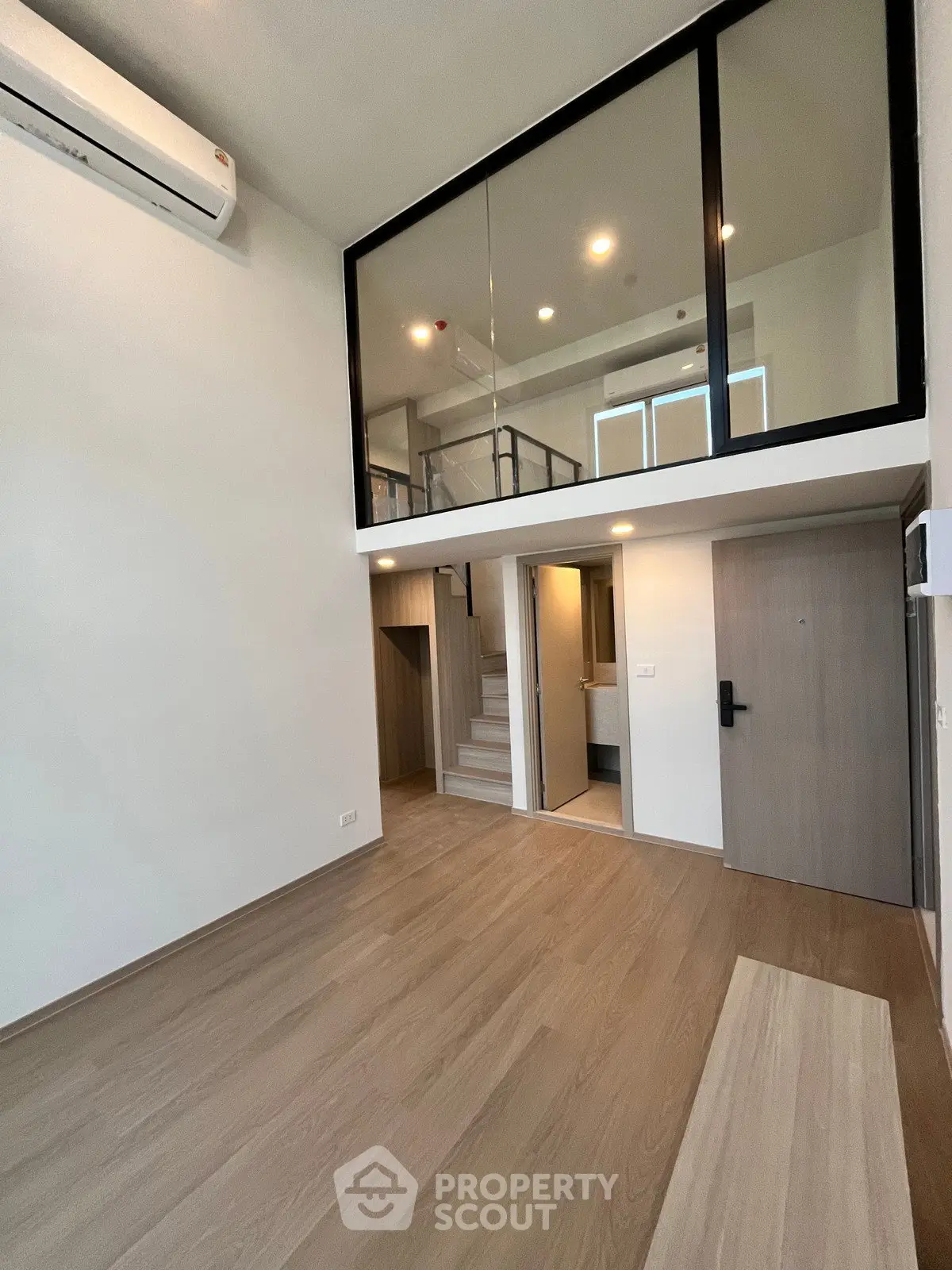 Modern duplex apartment with mezzanine and sleek wooden flooring