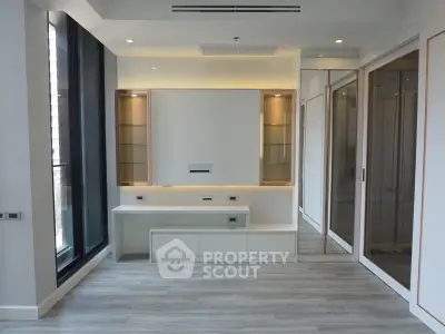 Modern living room with sleek built-in storage and large windows