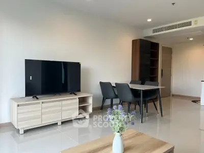 Modern living room with sleek furniture and dining area in a stylish apartment.