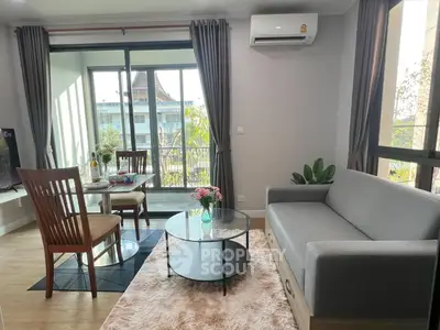 Modern living room with balcony view, stylish furniture, and natural light.