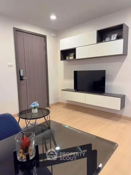 Modern living room with sleek furniture and mounted TV, perfect for contemporary urban living.