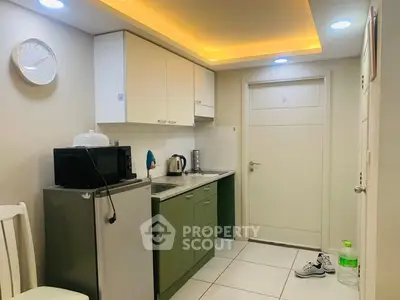 Compact kitchen with modern appliances and stylish lighting