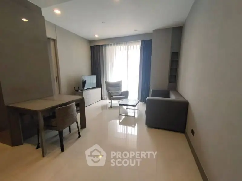 Modern living room with sleek furniture and natural light, perfect for relaxation and entertainment.