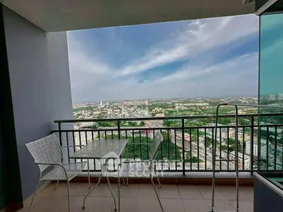 Stunning balcony view overlooking cityscape with modern outdoor furniture.