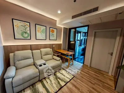 Cozy living room with modern decor and comfortable seating in a stylish apartment.