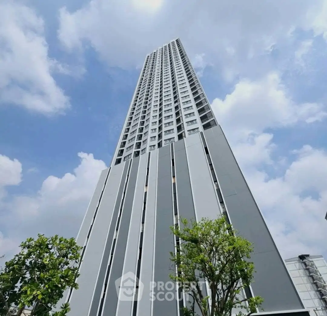 Stunning high-rise building with modern architecture against a blue sky backdrop.
