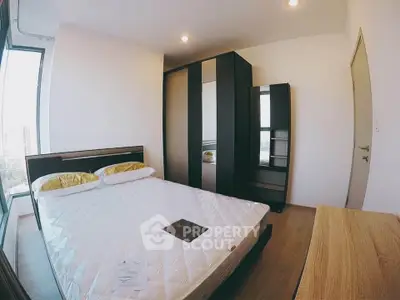 Modern bedroom with large wardrobe and natural light in urban apartment