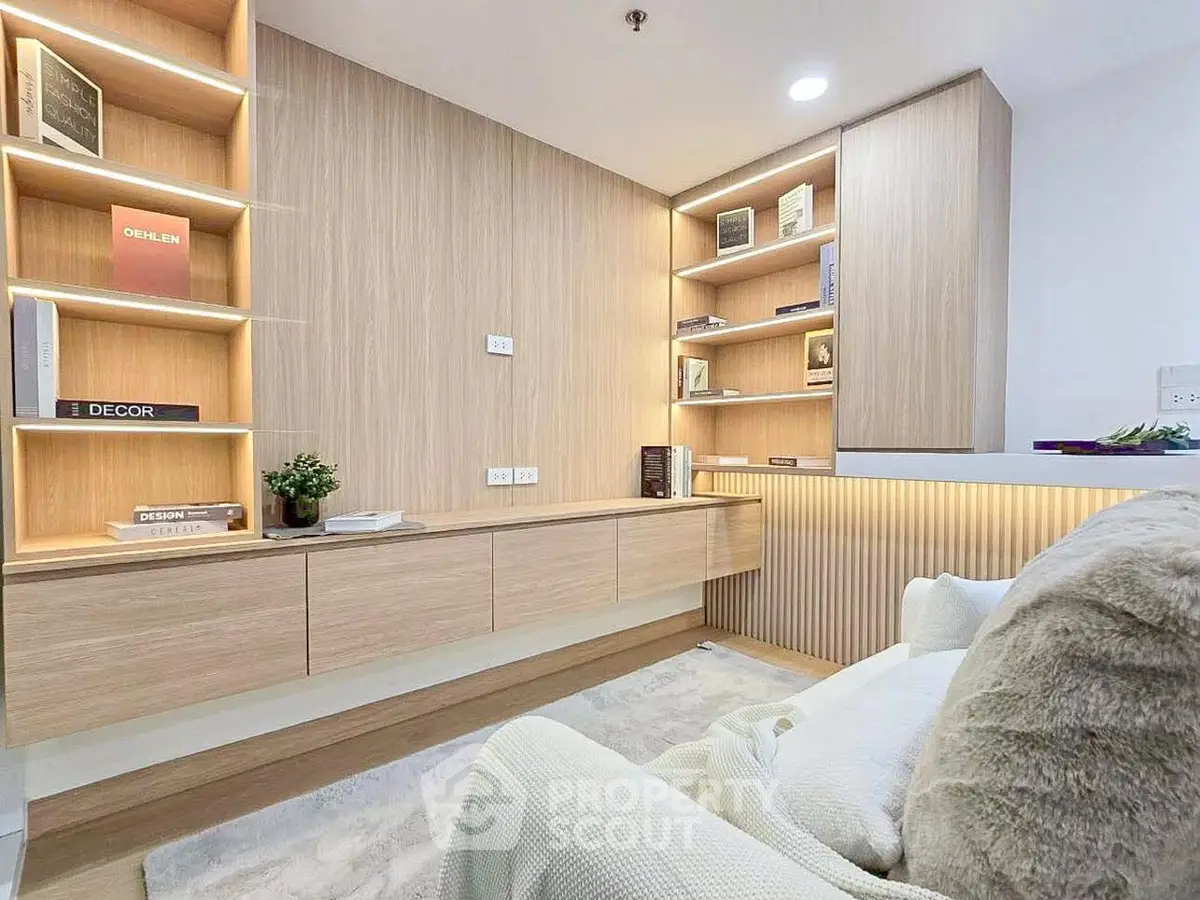 Modern study room with built-in wooden shelves and cozy seating area