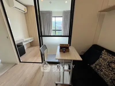 Modern compact living space with natural light and stylish furnishings