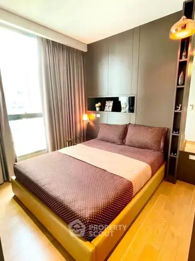 Modern bedroom with stylish decor and large window for natural light