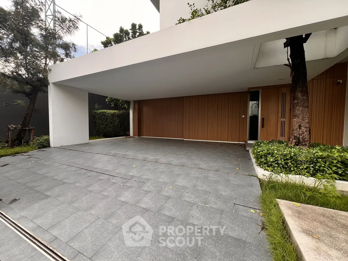 Modern covered parking area with sleek design and greenery, perfect for urban living.
