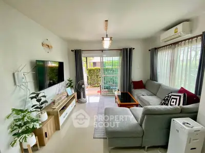 Spacious living room with modern decor and large windows for natural light.