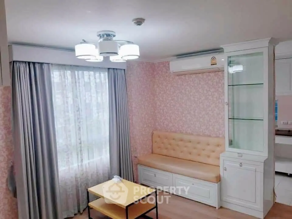 Cozy living room with elegant pastel decor, modern furniture, and ample natural light, perfect for comfortable urban living.