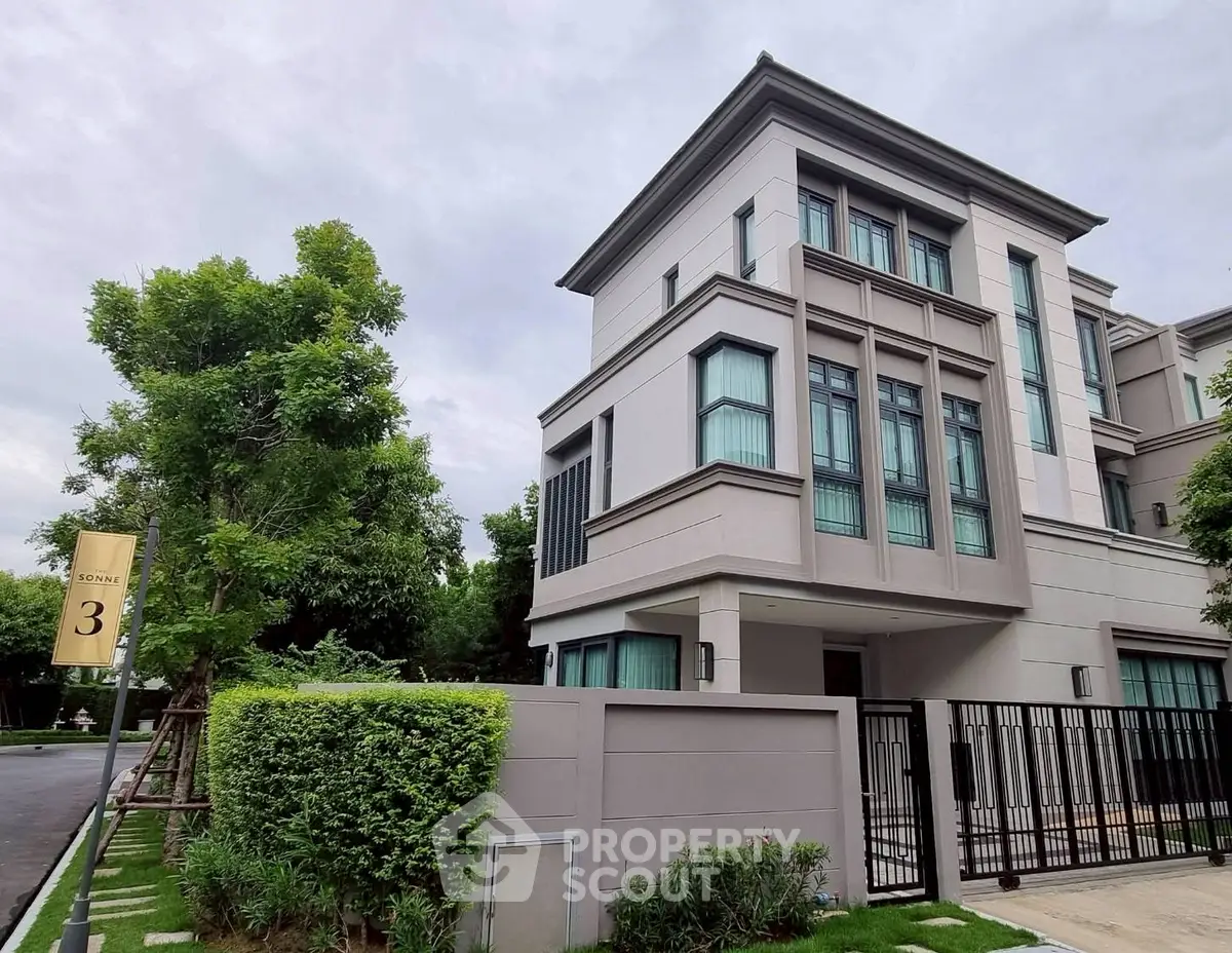 Luxurious modern house exterior with lush greenery and sleek architectural design.