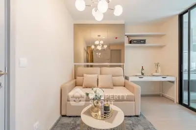 Modern living room with elegant beige sofa, stylish lighting, and chic decor in a cozy apartment.